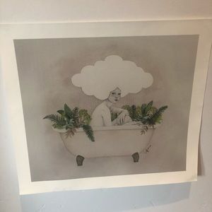 Lady in bath full of green foliage with a cloud